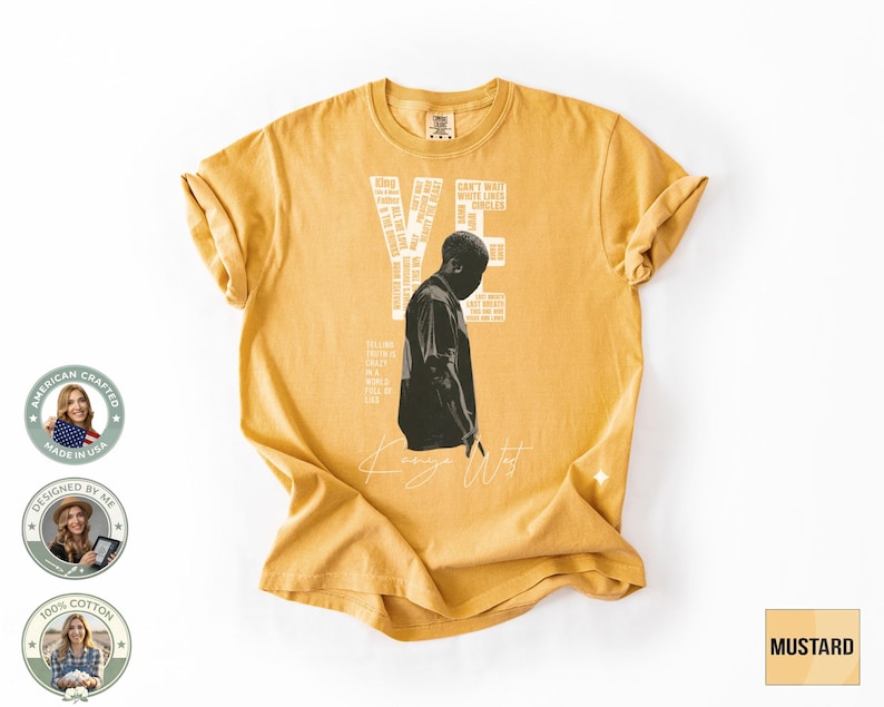 May include: Mustard-colored t-shirt featuring a black and white graphic of a person and the text "YE" and "Kanye West". The shirt also has additional text and is made of 100% cotton.