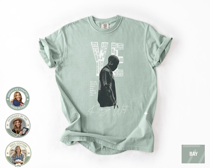 May include: A light green t-shirt featuring a black and white graphic of a person and the word "YE" in white. The shirt also has the words "Kanye West" in white script. The shirt is made of 100% cotton.