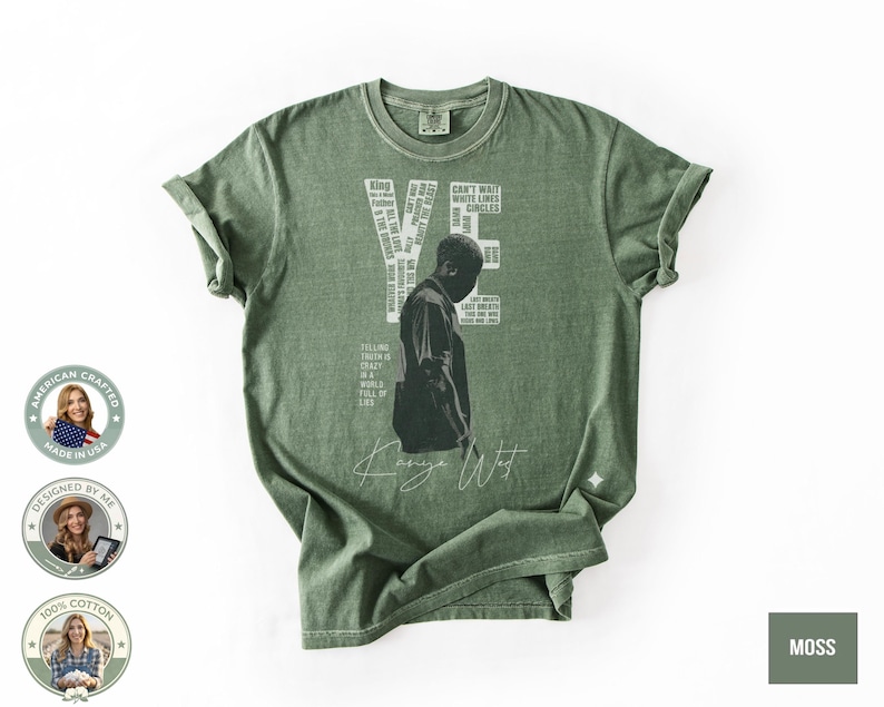 May include: Moss green t-shirt featuring a graphic of a person and the name "YE" in white block letters. The shirt also includes the text "Can't Wait" and "Circles". The words "Kanye West" are written in a cursive font. The shirt is made of 100% cotton.