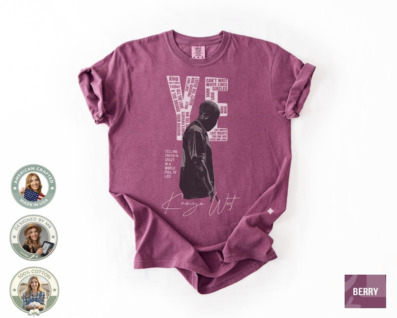 May include: Berry-colored t-shirt featuring a graphic of a person and the word "YE" in white. The shirt includes text elements and the signature "Kanye West". The shirt is made of 100% cotton.