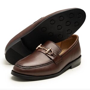 Handmade brown leather horsebit loafers for men featuring premium full-grain leather, elegant gold-tone horsebit hardware, classic moc-toe stitching, slip-on design, leather lining, and a refined style perfect for weddings, business, office, and everyday luxury wear.