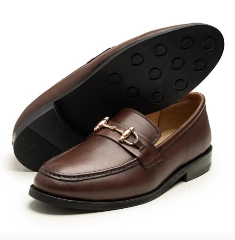 Handmade brown leather horsebit loafers for men featuring premium full-grain leather, elegant gold-tone horsebit hardware, classic moc-toe stitching, slip-on design, leather lining, and a refined style perfect for weddings, business, office, and everyday luxury wear.