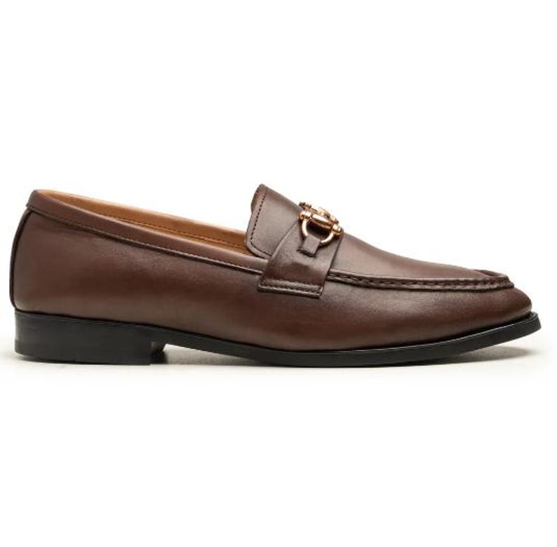 Handmade brown leather horsebit loafers for men featuring premium full-grain leather, elegant gold-tone horsebit hardware, classic moc-toe stitching, slip-on design, leather lining, and a refined style perfect for weddings, business, office, and everyday luxury wear.