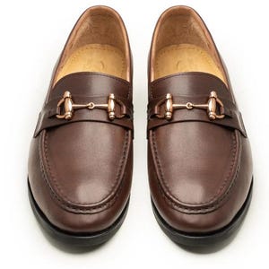 Handmade brown leather horsebit loafers for men featuring premium full-grain leather, elegant gold-tone horsebit hardware, classic moc-toe stitching, slip-on design, leather lining, and a refined style perfect for weddings, business, office, and everyday luxury wear.