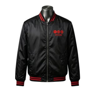 May include: A black bomber jacket featuring a full-length silver zipper, a ribbed collar, and ribbed cuffs with two red stripes. The chest displays a red graphic with three circular symbols and the text ARIRANG printed in red capital letters.