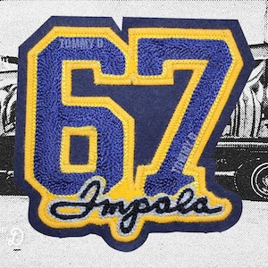 May include: A navy blue and yellow embroidered patch with the number "67" and the word "Impala". The patch has a yellow border and the text "Tommy D" is visible. The background is a black and white image of a car and graffiti.