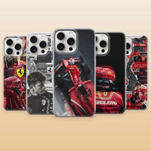 May include: Five phone cases with Formula 1 racing designs. The cases display images of race cars, drivers, and team logos in red, black, and white. Each case has a unique design, with some including text and portraits of the drivers.