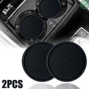 May include: Two circular black car cup holder inserts featuring a textured honeycomb pattern on the surface. These flexible rubber-like mats are designed to fit into vehicle console cup holders to provide a non-slip base for beverage containers.