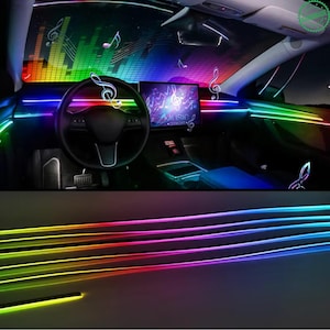 May include: Car interior with vibrant, multicolored LED strip lights. The lights wrap around the dashboard and console, creating a dynamic, colorful display. Musical notes and the word "MUSIC" are visible on the screen.