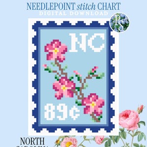 May include: A digital needlepoint stitch chart featuring a postage stamp design with a light blue background, a dark blue border, and a pixelated illustration of pink dogwood flowers. The text reads PETITE STITCHERY, NEEDLEPOINT stitch CHART, NC, 89¢, and NORTH CAROLINA.