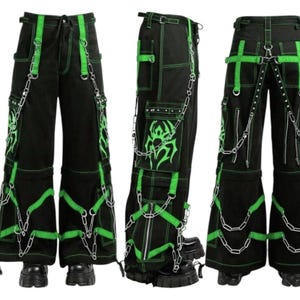 May include: Black cargo pants with neon green accents, stitching, and straps. The pants feature multiple pockets, decorative chains, and a graphic design on the leg. The text "Craft by Euro Wear" is visible on the left side.