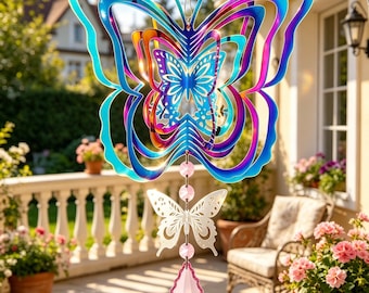 May include: A multi-layered, iridescent butterfly wind spinner with a smaller white butterfly and pink crystal pendant. The wind spinner features shades of blue, purple, and orange. The background shows a patio with potted flowers and a house.