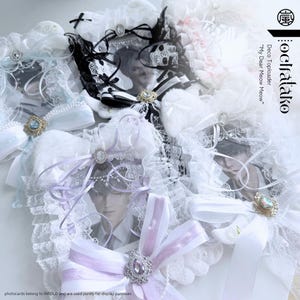 May include: An assortment of decorative card holders, adorned with lace, ribbons, and decorative elements. The holders are in white, black, and pastel hues, with images of a person. The image text reads "Deco Toploader My Dear Meow Meow".