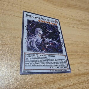 May include: A trading card featuring the character Skirk, Void Star Advent. The card has a dark color scheme with a female character illustration. The card text includes game mechanics and stats, with an ATK of 3200 and DEF of 3000.