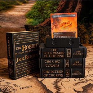 May include: A black storage box set designed to look like J.R.R. Tolkien books, including The Hobbit, The Fellowship of the Ring, The Two Towers, and The Return of the King, with a collectible trading card titled The One Ring displayed on top.