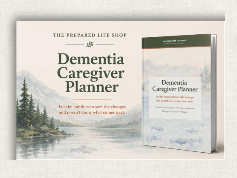 May include: A book titled "Dementia Caregiver Planner" with a landscape illustration of a lake and mountains. The cover text includes "For the family who sees the changes and doesn't know what comes next." The book is from The Prepared Life Shop.