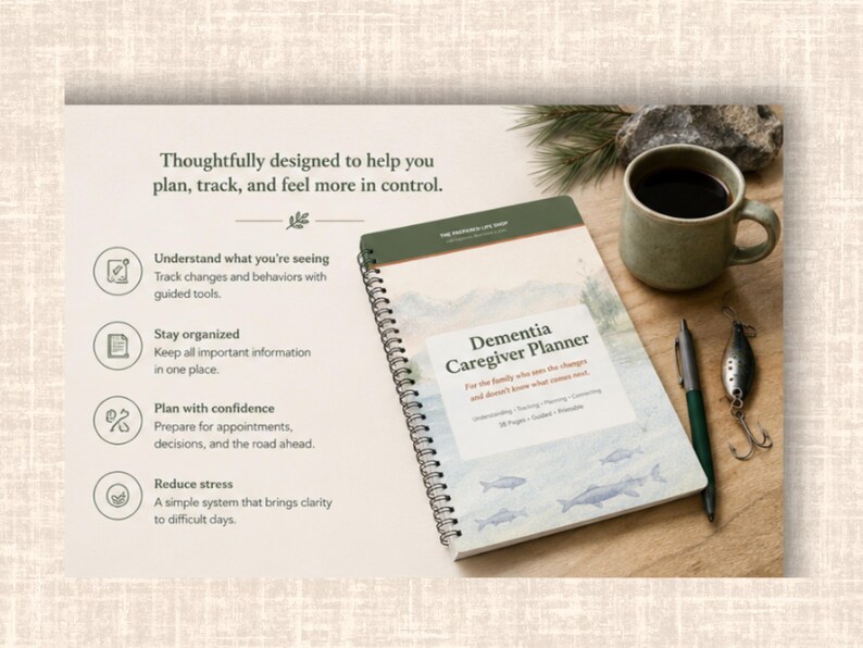 May include: A spiral-bound Dementia Caregiver Planner with a green and white cover, a mug of coffee, a pen, and a fishing lure on a wooden surface. The planner's cover features a watercolor illustration of fish.