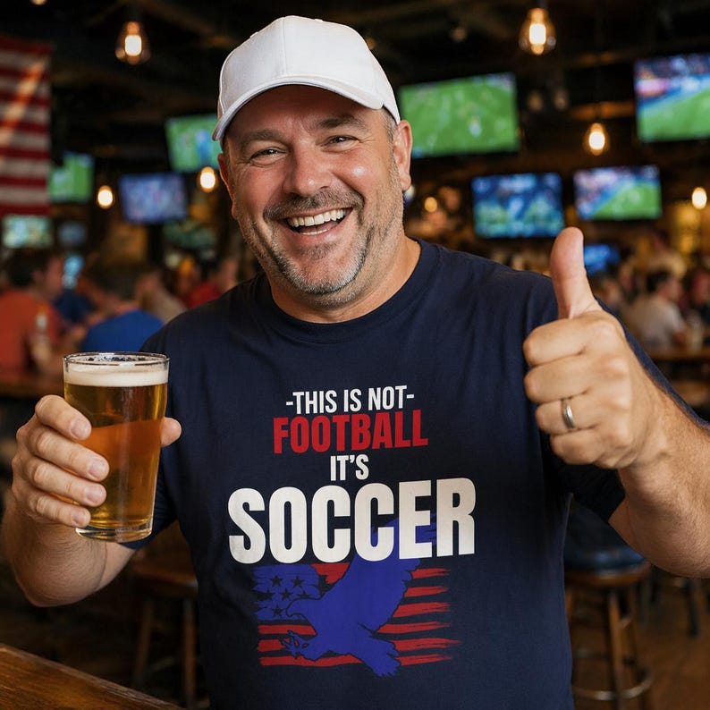 Man wearing USA soccer shirt saying This Is Not Football It's Soccer funny American fan tee in sports bar
