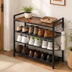 May include: A four-tier shoe rack with a black metal frame and a dark wood-grain top shelf. The unit features three mesh shelves for footwear, a side rack with five hooks for accessories, and a white umbrella hanging from the side frame.
