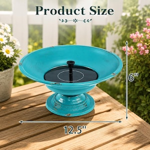 May include: A turquoise pedestal bird bath with a distressed finish and a central black solar panel. The bowl measures 12.5 inches in diameter and the total height of the unit is 6 inches, as indicated by the text and arrows in the image.