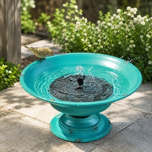 May include: A turquoise birdbath with a distressed finish and a circular pedestal base. A small yellow and grey bird perches on the rim. A black solar-powered fountain pump sits in the centre of the basin, spraying a small stream of water upwards.