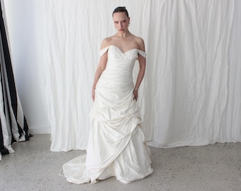 El vestido de novia vintage asimétrico de seda color crema ligero, fruncido y con textura, más chic de los años 2000, con cola.