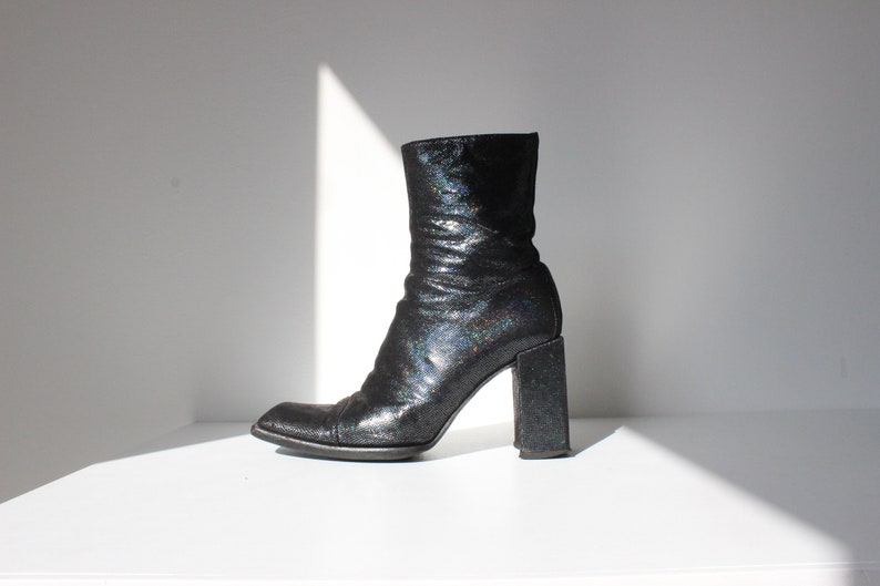 May include: Black ankle boots with a chunky heel and iridescent glitter finish.