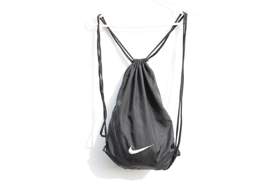 black nike bag with white tick