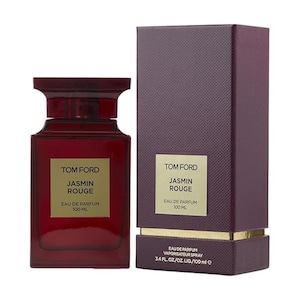 May include: A dark red Tom Ford Jasmin Rouge Eau de Parfum bottle and box. The bottle is rectangular with a dark red cap. The box is a textured dark red with gold accents. The text "TOM FORD JASMIN ROUGE EAU DE PARFUM 100 ML" is visible.