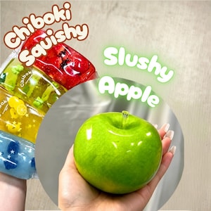 May include: A Chiboki Squishy toy shaped like a bright green apple with a clear stem, alongside a stack of four rectangular, translucent, colorful gel-filled pouches labeled Chiboki Squishy and Slushy Apple with various embedded shapes.