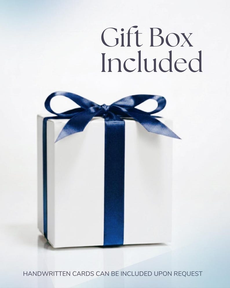 Pode incluir: Uma caixa de presente branca com uma fita e la&ccedil;o azul marinho. O texto "Gift Box Included" est&aacute; no topo. O texto "HANDWRITTEN CARDS CAN BE INCLUDED UPON REQUEST" est&aacute; na parte inferior.