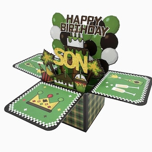 May include: A pop-up birthday card with a green and brown plaid exterior. The card features a pixelated design with a cake, balloons, and the words "HAPPY BIRTHDAY SON". The card is decorated with green, white, and brown balloons.