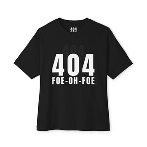 May include: Black t-shirt with the number "404" in large white font, and the words "FOE-OH-FOE" below it. A smaller "404" is printed above the larger one. The shirt is a short-sleeved crew neck.