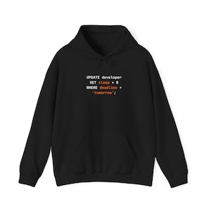 May include: A black hooded sweatshirt featuring white and orange text on the chest that reads: UPDATE developer SET sleep = 0 WHERE deadline = 'tomorrow';. The garment includes a front kangaroo pocket, long sleeves, and a drawstring hood.