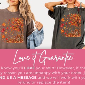 May include: Two short-sleeve t-shirts in espresso brown and pepper gray, each featuring a graphic print of a tree with falling autumn leaves in shades of orange, red, and yellow, with a bicycle parked at the base of the tree trunk.
