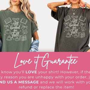 May include: Two short-sleeve crew neck t-shirts in moss green and pepper gray. Each shirt features a white graphic print with the text All booked for Fall, surrounded by illustrations of open books, eyeglasses, bows, pumpkins, a leaf, and a coffee cup.