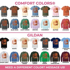 May include: A color chart displaying Comfort Colors 1717 shirts and 1566 sweatshirts, alongside Gildan 5000 shirts and 18000 sweatshirts. Each garment features a graphic of a tree with autumn leaves. The chart lists various color names for each style.