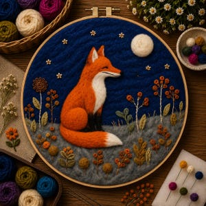 May include: A handmade embroidery hoop art piece depicting a fox. The fox is orange and white, set against a blue night sky with a full moon and stars. The scene includes detailed floral and plant elements, all within a wooden hoop.