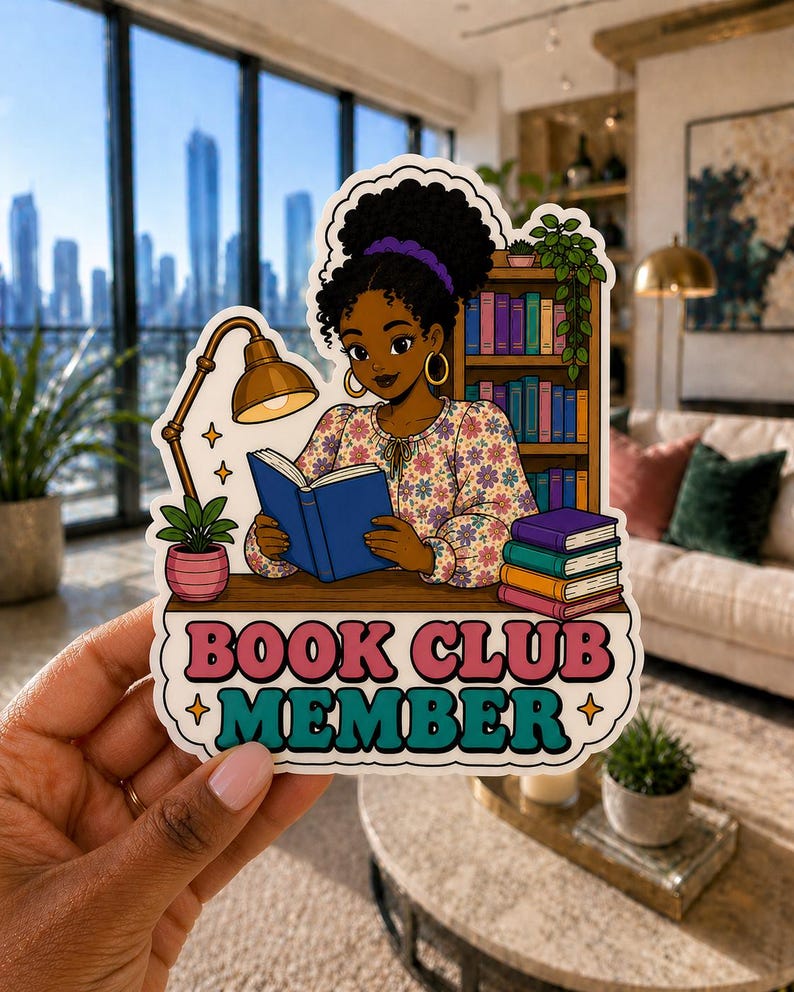 May include: A sticker featuring a cartoon illustration of a person reading a book, with a bookshelf in the background. The sticker reads "BOOK CLUB MEMBER" in pink and teal lettering. The person is wearing a floral top and has dark hair.