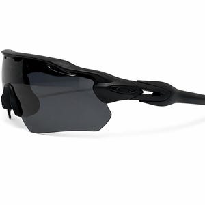 May include: Matte black performance sunglasses featuring a single continuous dark gray shield lens. The frame has a sleek, aerodynamic design with integrated side temples and a black nose bridge piece, showcasing the Oakley logo on the temple arm.