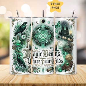 May include: A cylindrical tumbler featuring a white background with green and black illustrations of ravens, crystals, keys, a castle, a spellbook, and a pendulum. The text "Magic Begins Where Fear Ends" is printed in a decorative black font.