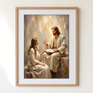 Op de afbeelding: Een ingelijste prent die een religieuze scène weergeeft. Twee figuren in witte gewaden zitten en praten. Eén houdt een open boek vast. De achtergrond heeft zachte, warme tinten, wat een vredige sfeer creëert. Het kunstwerk is ingelijst in een lichtgekleurde houten lijst.