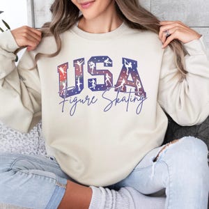 Sand colored USA Figure Skating sweatshirt with red white blue skater design, relaxed fit skating mom crewneck, patriotic winter sports shirt, ice rink competition outfit.
