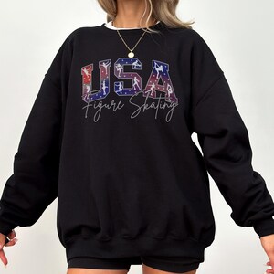Black USA Figure Skating sweatshirt with bold patriotic skating graphic, cozy crewneck for skating fans, ice skating mom gift, winter sports apparel.