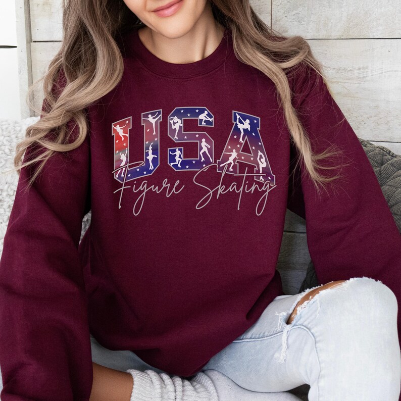 Burgundy USA Figure Skating crewneck sweatshirt with patriotic skater silhouettes inside varsity letters, cozy skating mom gift, winter rink competition outfit, figure skating fan apparel.
