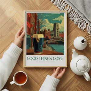 May include: A framed art print featuring a pint of stout with a gold head, set against a cityscape with a bridge and buildings. The print includes the text "GOOD THINGS COME TO THOSE WHO WAIT."