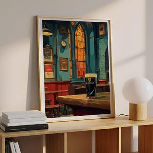 May include: Framed print of a pub interior with a pint of Guinness on a wooden table. The artwork features a dark, moody color palette with red, blue, and orange tones. The Guinness glass is centered, with the logo visible.