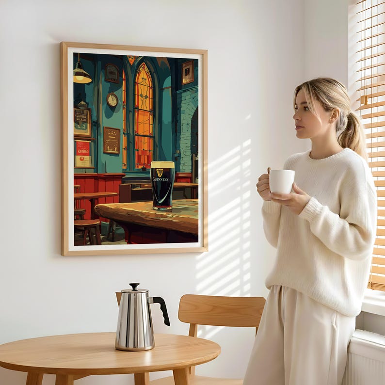 May include: A framed print depicts a pub scene with a pint of Guinness on a wooden table. The artwork features a stained-glass window, a clock, and various framed signs. The color palette includes shades of teal, red, and gold, creating a warm and inviting atmosphere.