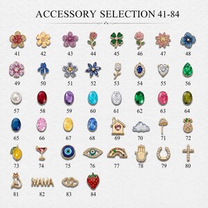 May include: A grid of small decorative charms labelled 41-84 under the text ACCESSORY SELECTION 41-84. The collection includes various shapes such as flowers, gemstones, fruits, symbols, and animals, featuring gold-tone metal and colourful accents.