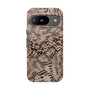May include: A smartphone case with a snakeskin pattern in shades of brown and tan. The case has a camera cutout and buttons on the side. The design mimics the texture and color of reptile skin.